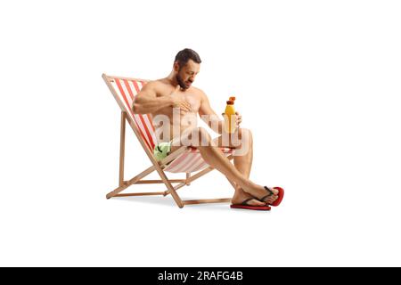 Man sitting on a deck chair and putting on sun cream isolated on white background Stock Photo