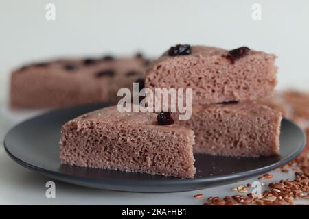 Slices of Navara rice vattayappam. Steamed rice cake made with a fermented batter of navara rice and coconut and steamed in a round dish. A version of Stock Photo