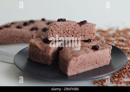 Slices of Navara rice vattayappam. Steamed rice cake made with a fermented batter of navara rice and coconut and steamed in a round dish. A version of Stock Photo