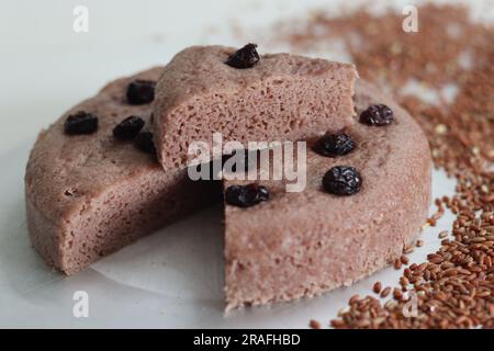 Slices of Navara rice vattayappam. Steamed rice cake made with a fermented batter of navara rice and coconut and steamed in a round dish. A version of Stock Photo