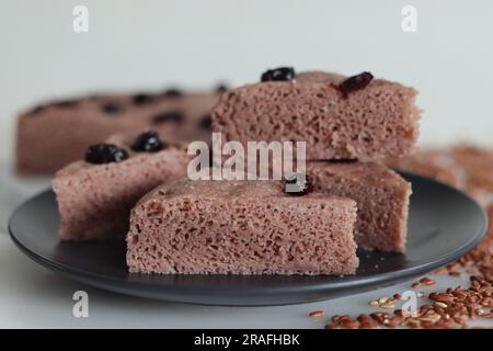 Slices of Navara rice vattayappam. Steamed rice cake made with a fermented batter of navara rice and coconut and steamed in a round dish. A version of Stock Photo