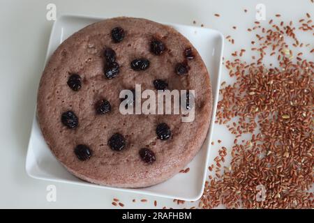 Navara rice vattayappam. Steamed rice cake made with a fermented batter of navara rice and coconut and steamed in a round dish. A version of tradition Stock Photo