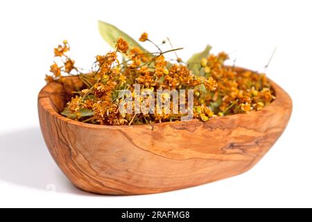 Dried lime blossoms in a wooden bowl Stock Photo
