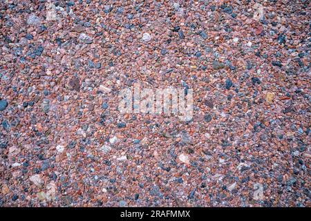 Background of small tiny colored pebbles. Background of pebbles of different shapes and colors. Stock Photo