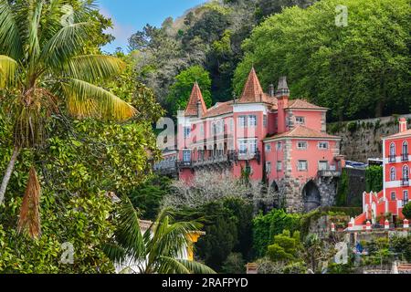 The Casa Dos Penedos in the hills overlooking the historic town centre in Sintra, Portugal. The Romanticist architectural and fairytale palaces draws tourists from around the world. Stock Photo