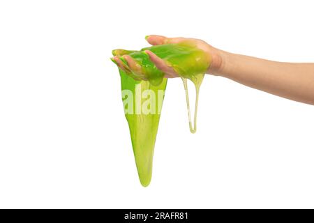 Green slime toy in woman hand with green nails isolated on a white background. Stock Photo