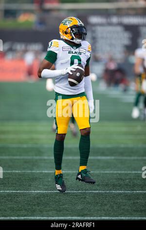 BC Lions' Justin McInnis (18) is tackled by Hamilton Tiger-Cats