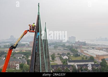 Detroit, Michigan - Workers repair the towers of the Basilica of Ste. Anne de Detroit. Ste. Anne was founded by French explorers in 1701. This buildin Stock Photo