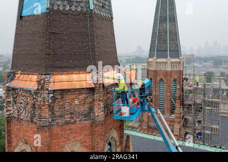 Detroit, Michigan - Workers repair the towers of the Basilica of Ste. Anne de Detroit. Ste. Anne was founded by French explorers in 1701. This buildin Stock Photo