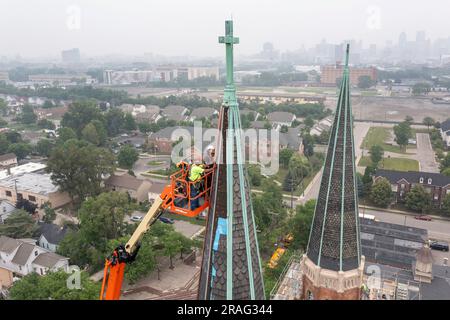 Detroit, Michigan - Workers repair the towers of the Basilica of Ste. Anne de Detroit. Ste. Anne was founded by French explorers in 1701. This buildin Stock Photo