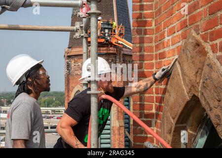 Detroit, Michigan - Kevin Driscoll (right) and Anthony Powell clean and repair the bell towers of the Basilica of Ste. Anne de Detroit. Ste. Anne was Stock Photo