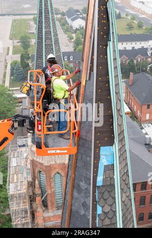 Detroit, Michigan - Workers repair the towers of the Basilica of Ste. Anne de Detroit. Ste. Anne was founded by French explorers in 1701. This buildin Stock Photo