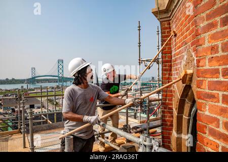 Detroit, Michigan - Anthony Powell (left) and Kevin Driscoll clean and repair the bell towers of the Basilica of Ste. Anne de Detroit. Ste. Anne was f Stock Photo