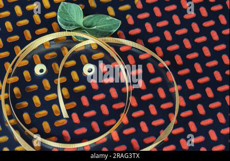 Text space on abstract geometric pattern background is highlighted with ribbon face, eyes, leaves. See happy pumpkin round against orange & red colors. Stock Photo