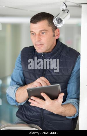professional cctv technician working with tablet Stock Photo