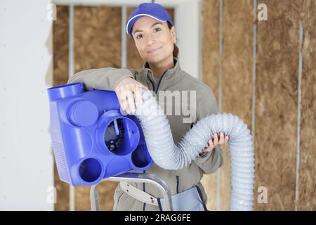 happy female electrician working with cables Stock Photo