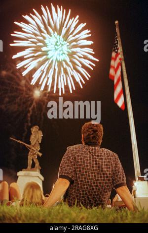 Gary O'connell (right) and his wife, Diane O'connell, of Dayton, OH, watch a burst of fireworks exploding over Monument Square and a Spirit of the American Doughboy statue during the Lakefest Fourth of July Celebration on Saturday, July 3, 1999 in Jamestown, Russell County, KY, USA. Mr. O'connell said the family owns a cabin on Lake Cumberland and has been vacationing in Russell County for many years. (Apex MediaWire Photo by Billy Suratt) Stock Photo