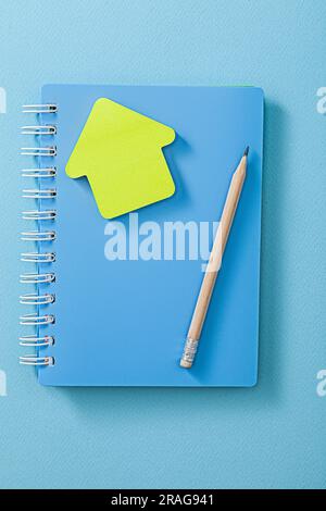 Blue Note Pad Wooden Pencil And Yellow Sticky Note Stock Photo