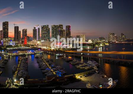 Miami marina harbor and skyscrapers of Brickell, city financial center. Skyviews Miami Observation Wheel at Bayside Marketplace with reflections in Bi Stock Photo