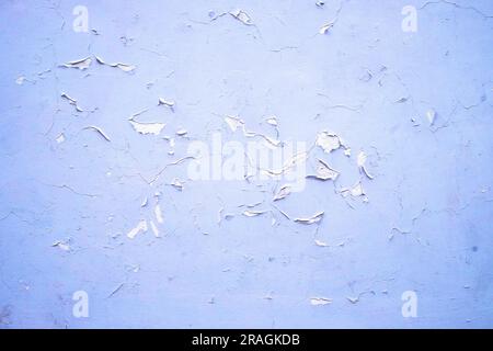 Bluish white wall with flaking paint. Stock Photo