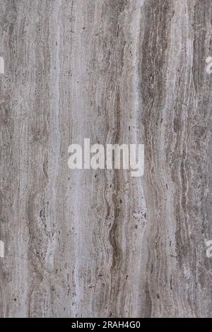 Surface and texture of smoky granite with vertical stripes and blotches. Natural gray texture and background. Vertical image. Stock Photo