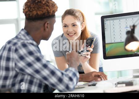 young attractive students of mechatronics working on project Stock Photo