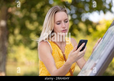 beautiful young woman using smart-phone outdoors Stock Photo