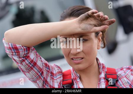 a frustrated woman near her broken car Stock Photo