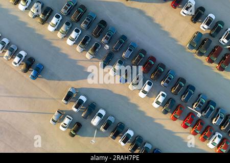 View from above of dealers outdoor parking lot with many brand new cars in stock for sale. Concept of development of american automotive industry Stock Photo