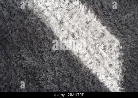 Sunlight on the cotton grey carpet. Grey carpet background. Sunshine on background. Stock Photo