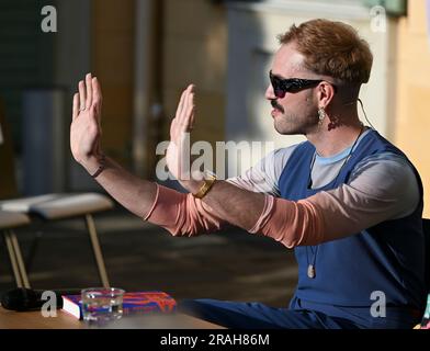 Potsdam, Germany. 02nd July, 2023. Kim de l'Horizon reads from his work 'Blood Book' in the garden of Villa Quandt at the Potsdam literature festival LIT:Potsdam. Credit: Jens Kalaene/dpa/Alamy Live News Stock Photo