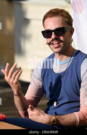 Potsdam, Germany. 02nd July, 2023. Kim de l'Horizon reads from his work 'Blood Book' in the garden of Villa Quandt at the Potsdam literature festival LIT:Potsdam. Credit: Jens Kalaene/dpa/Alamy Live News Stock Photo