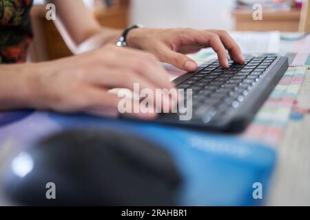 Young man software developer working from home on his laptop Stock Photo