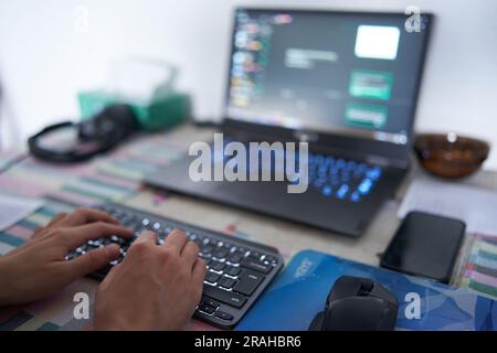 Young man software developer working from home on his laptop Stock Photo