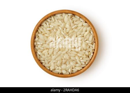 Carnaroli rice in wooden bowl on white background Stock Photo