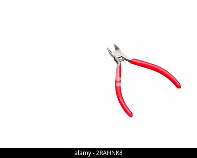 old diagonal cutting pliers with green and red on white background Stock Photo