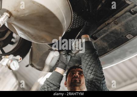 Car mechanic changing oil in a car service Stock Photo