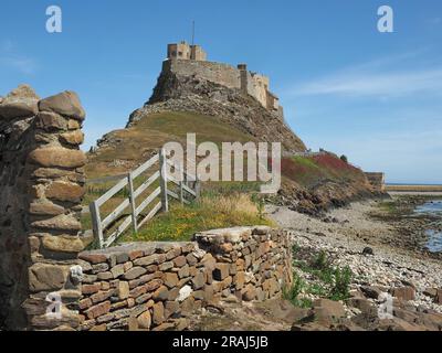 classic sunny view of Lindisfarne Castle on highest part of whinstone hill (Beblowe) on Holy Island, Northumbria, England,UK Stock Photo