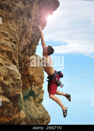 extreme climber man caught on a rock Stock Photo - Alamy