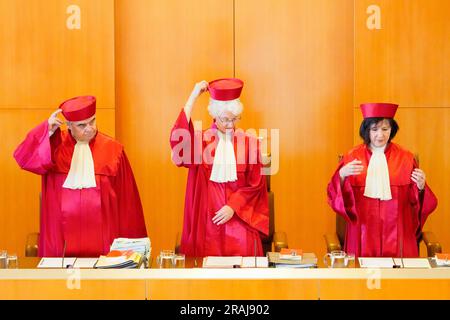 Karlsruhe, Germany. 04th July, 2023. The judges of the second senate - Peter Müller (l-r), Doris König, vice president and chairwoman of the second senate, and Sibylle Kessal-Wulf - enter the hearing room. The oral proceedings at the Federal Constitutional Court are looking into the question of whether the NPD can be excluded from state party funding. Credit: Uwe Anspach/dpa/Alamy Live News Stock Photo