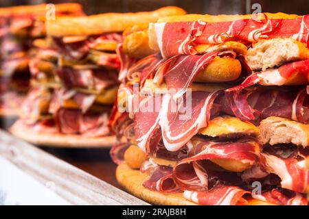 Traditional Spanish bocadillos laid out in a slide on a shop window Stock Photo