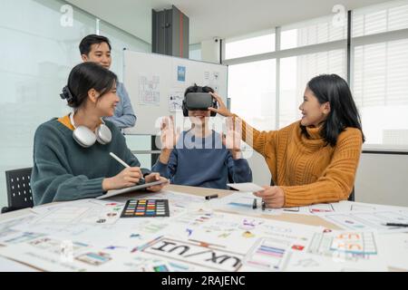 Diverse development team testing virtual reality headset, brainstorming on augmented reality improvement, future technology Stock Photo