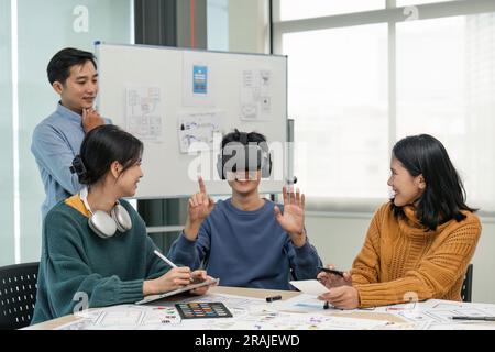 Diverse development team testing virtual reality headset, brainstorming on augmented reality improvement, future technology Stock Photo