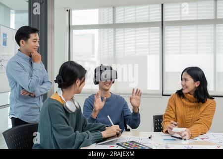 Diverse development team testing virtual reality headset, brainstorming on augmented reality improvement, future technology Stock Photo