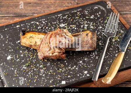 Beef rib asado on stone cutting board at steakhouse Stock Photo