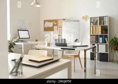 Modern office with workplaces with computers and flipchart for presentation Stock Photo