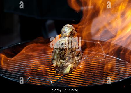 Grill steak tomahawk. Angus beef tbone on fire flame. Wood charcoal bbq, roast smoke cooking, outdoors restaurant. Hot barbeque food, t bone closeup Stock Photo