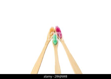 Three multicolored bamboo toothbrushes isolated on a white background. copyspace. Oral hygiene. Environmentally friendly product. Recyclable raw mater Stock Photo
