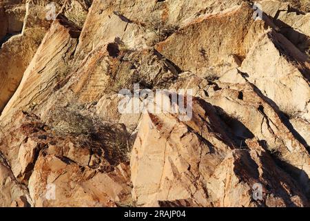 Layered rocks and hills. Surface of a natural stone brown colour Stock Photo