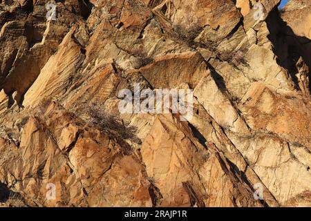 Layered rocks and hills. Surface of a natural stone brown colour Stock Photo